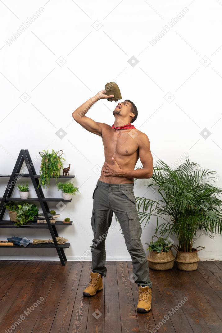 Good looking young man drinking from the flask