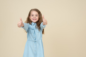 Cute little girl showing thumbs up