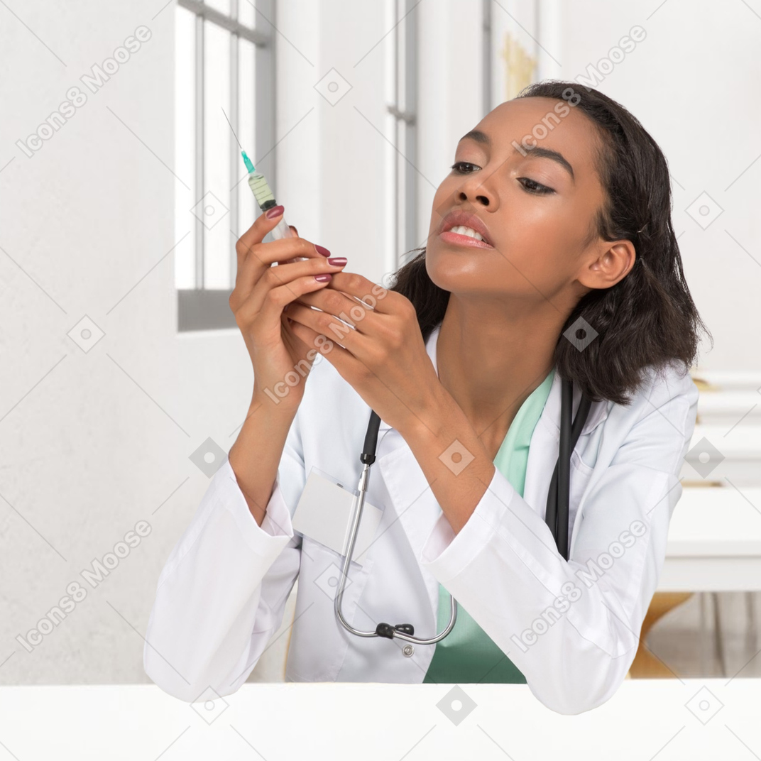 A woman in a white coat is holding a syringe