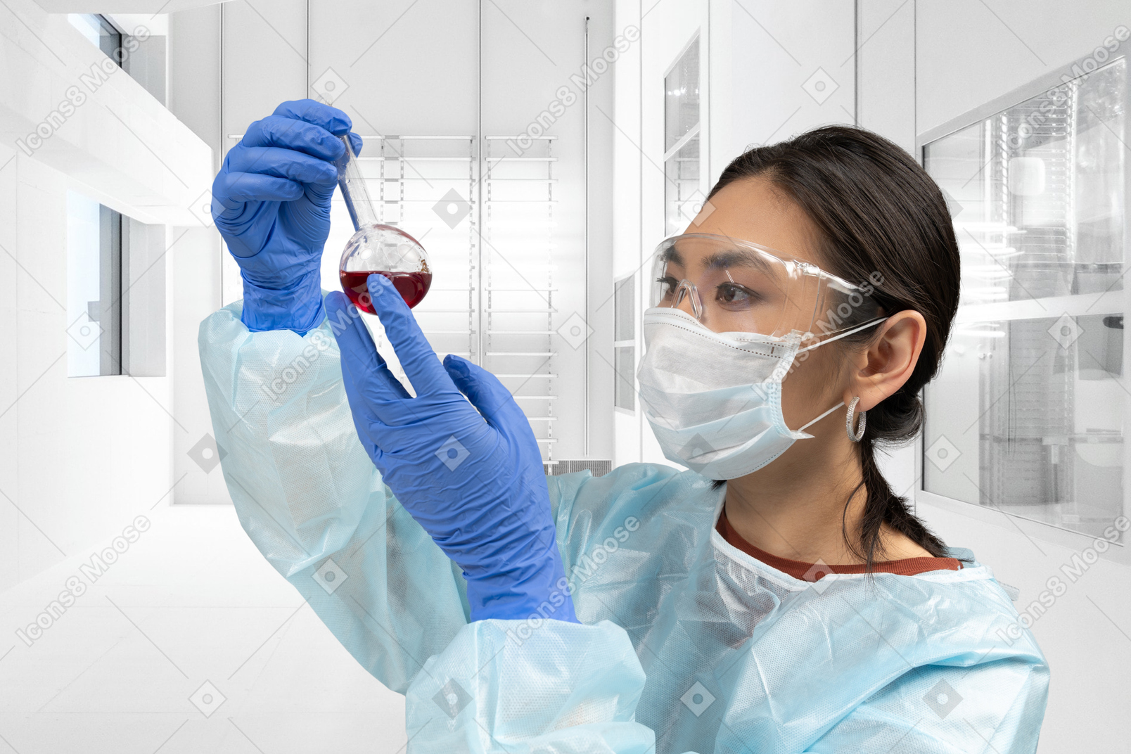 A woman in a lab coat holding a flask of liquid