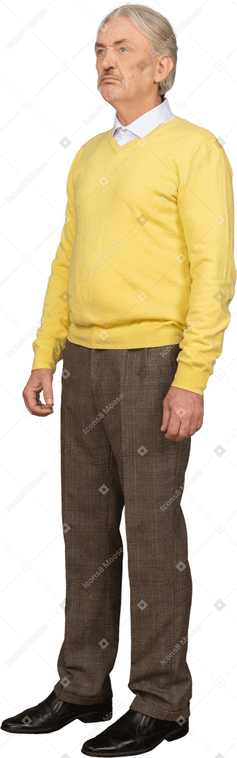 Three-quarter view of a displeased old man wearing yellow pullover and looking up