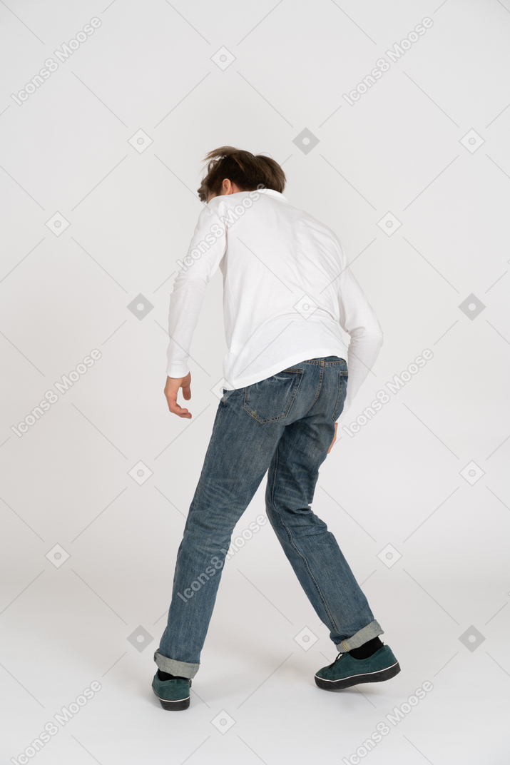 Young man in casual clothes dancing
