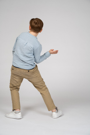 Back view of a boy in blue shirt