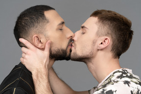 Close-up of two young men kissing softly