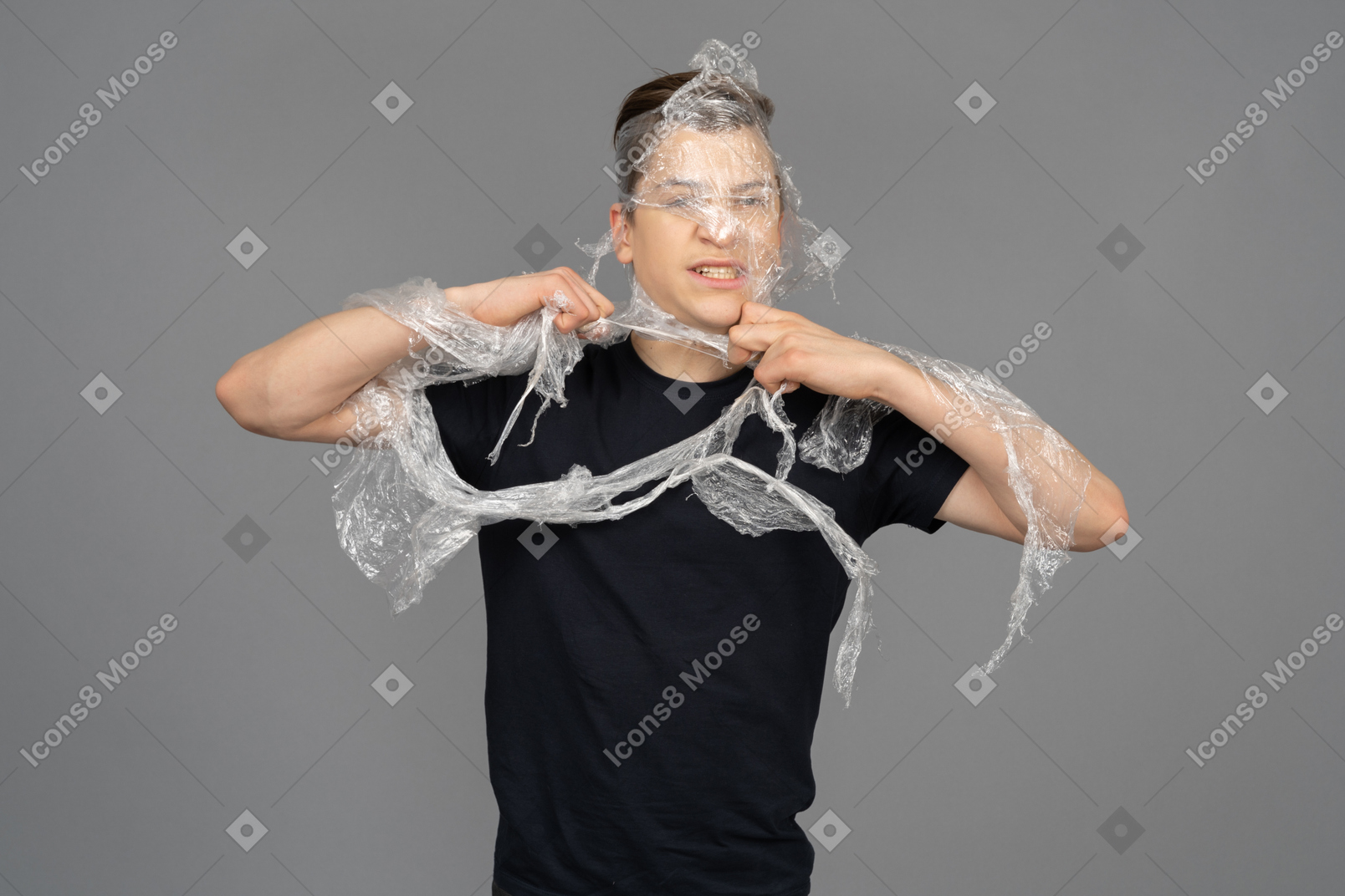 Young man wrapping plastic around him