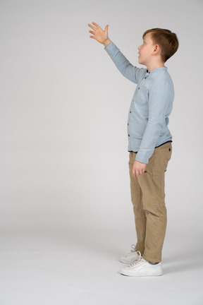 A young boy in a blue shirt and khaki pants