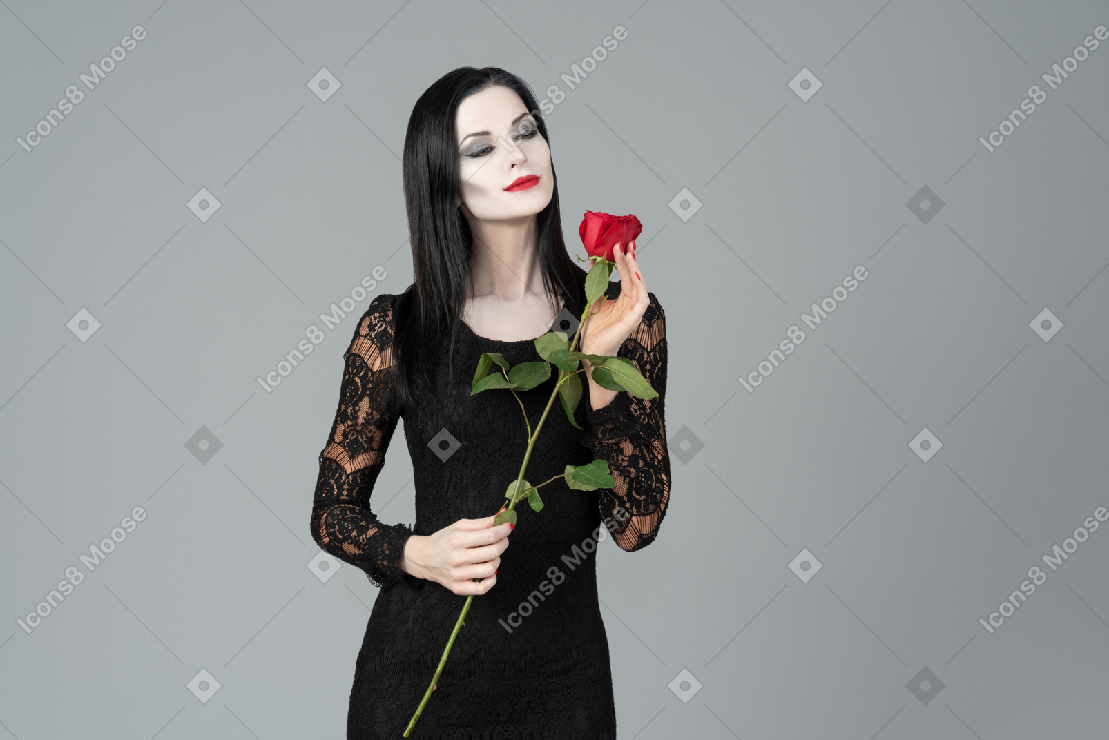 Morticia addams smelling red rose