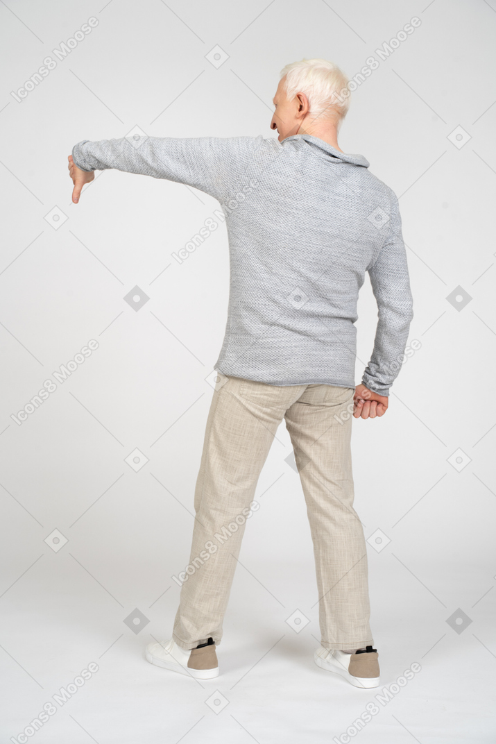 Rear view of man giving thumbs down