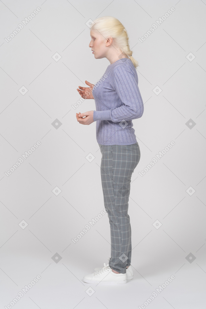Side view of young woman talking and gesturing