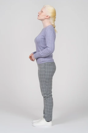 Side view of a woman looking upwards with her hands folded