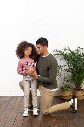 Young man on a knee with his daughter