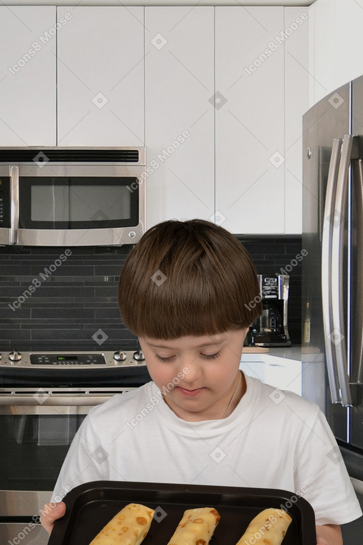 Little boy holding a tray with food