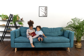 Cute boy and girl reading the book