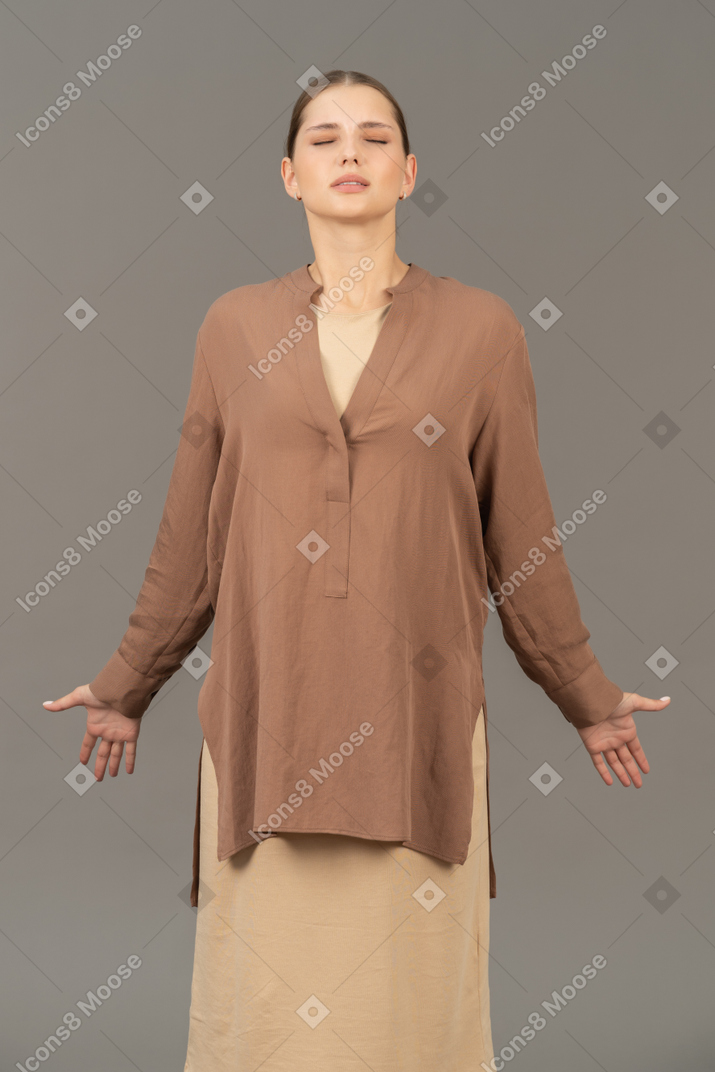 Front view of a wincing woman with arms wide open