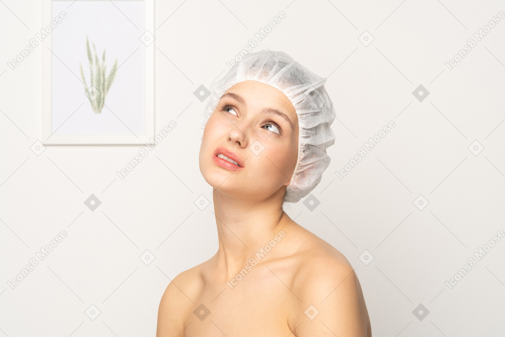 Doubting woman in medical cap looking up