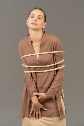 Lady with closed eyes bounded with a rope