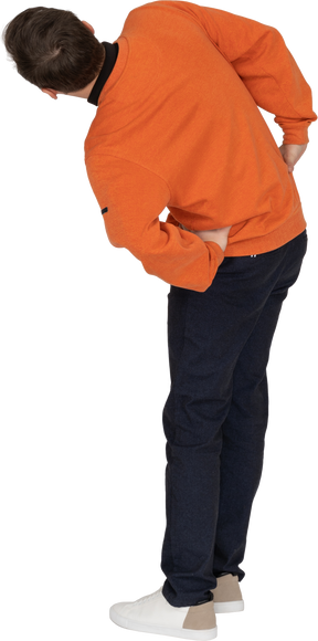 Young man in orange sweatshirt posing