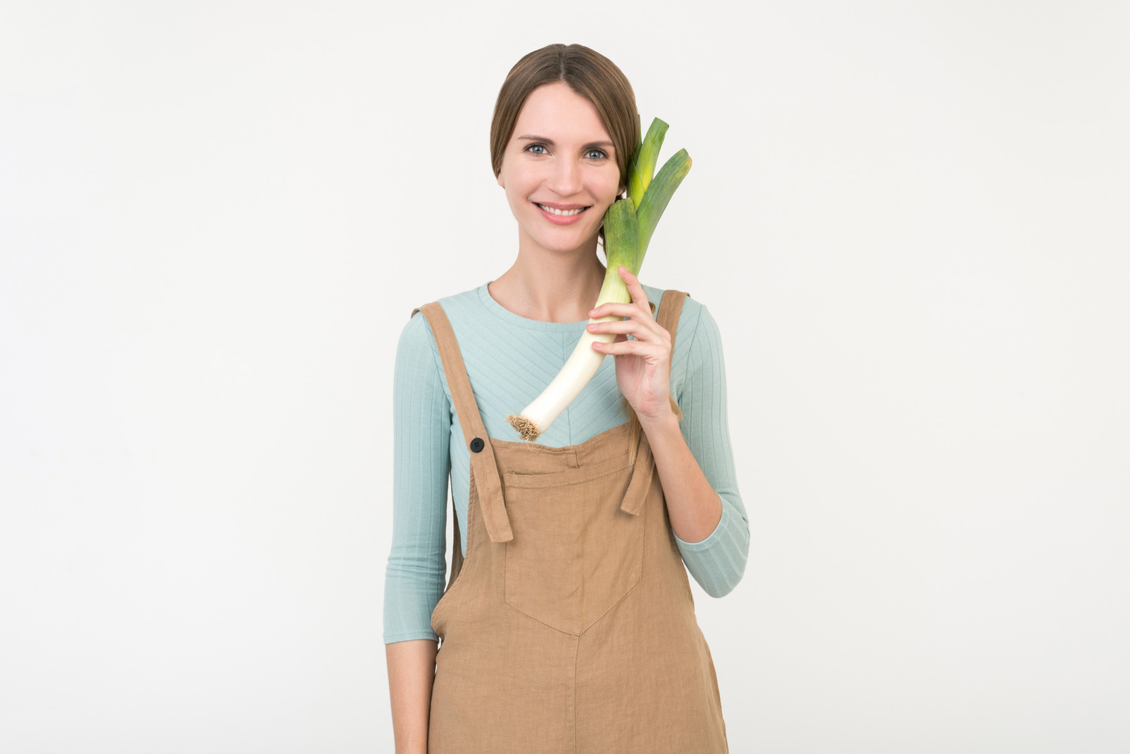 Young female farmer holding leek onion