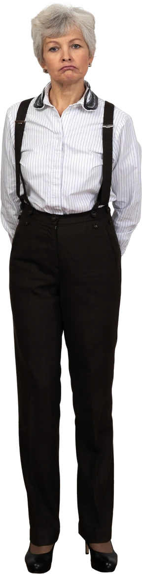 Front view of an old female in office clothes standing still in the room