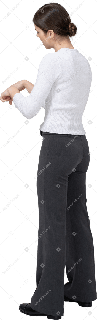 Side view of a young woman in casual clothes gesturing