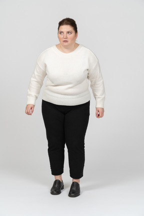 Scared plump woman in casual clothes