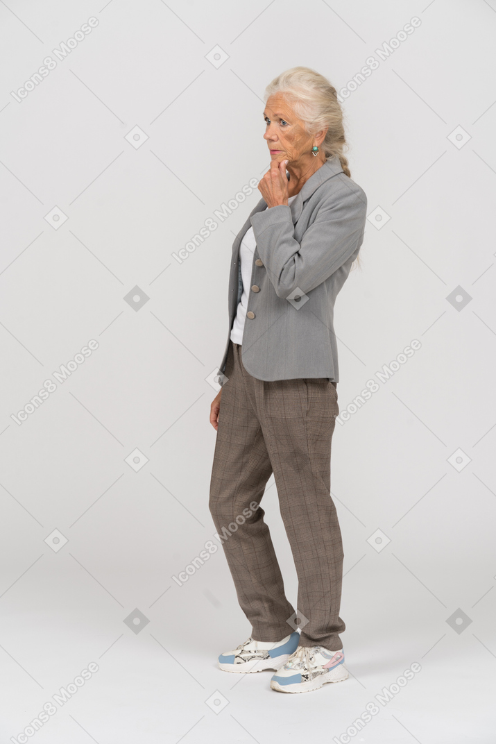 Side view of a thoughtful old lady in suit
