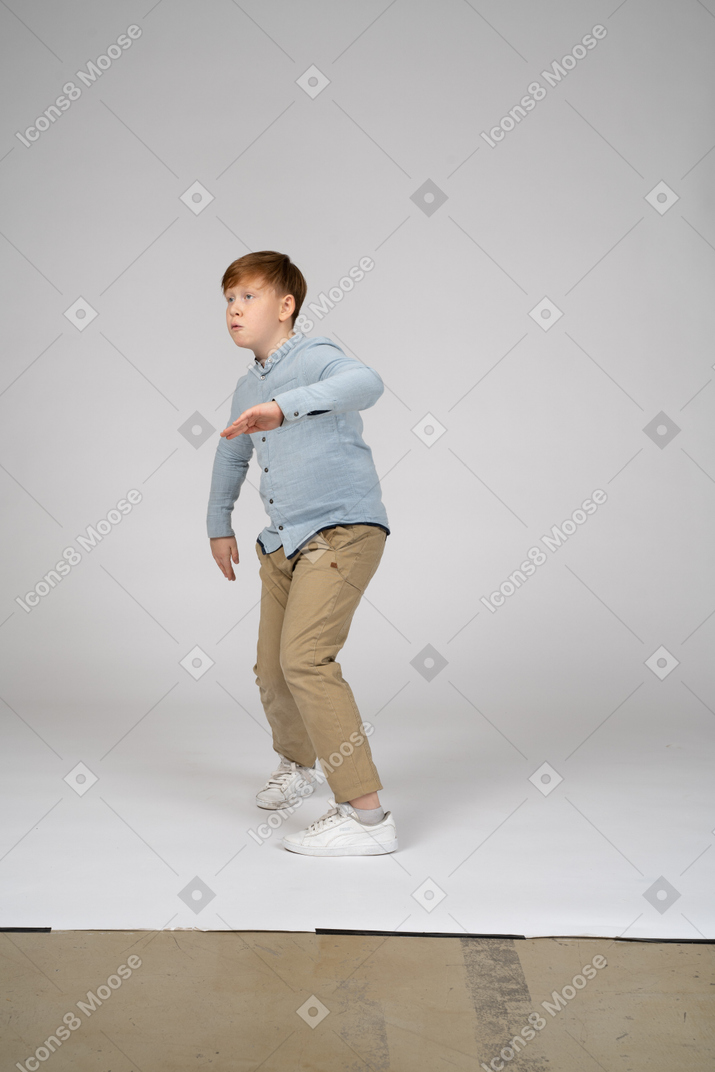 Boy in blue shirt dancing