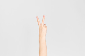 Female hand showing v sign