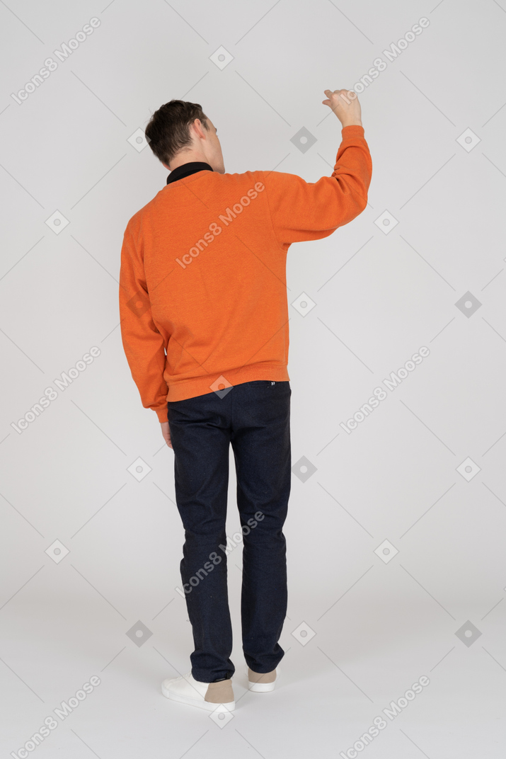 Young man in orange sweatshirt standing