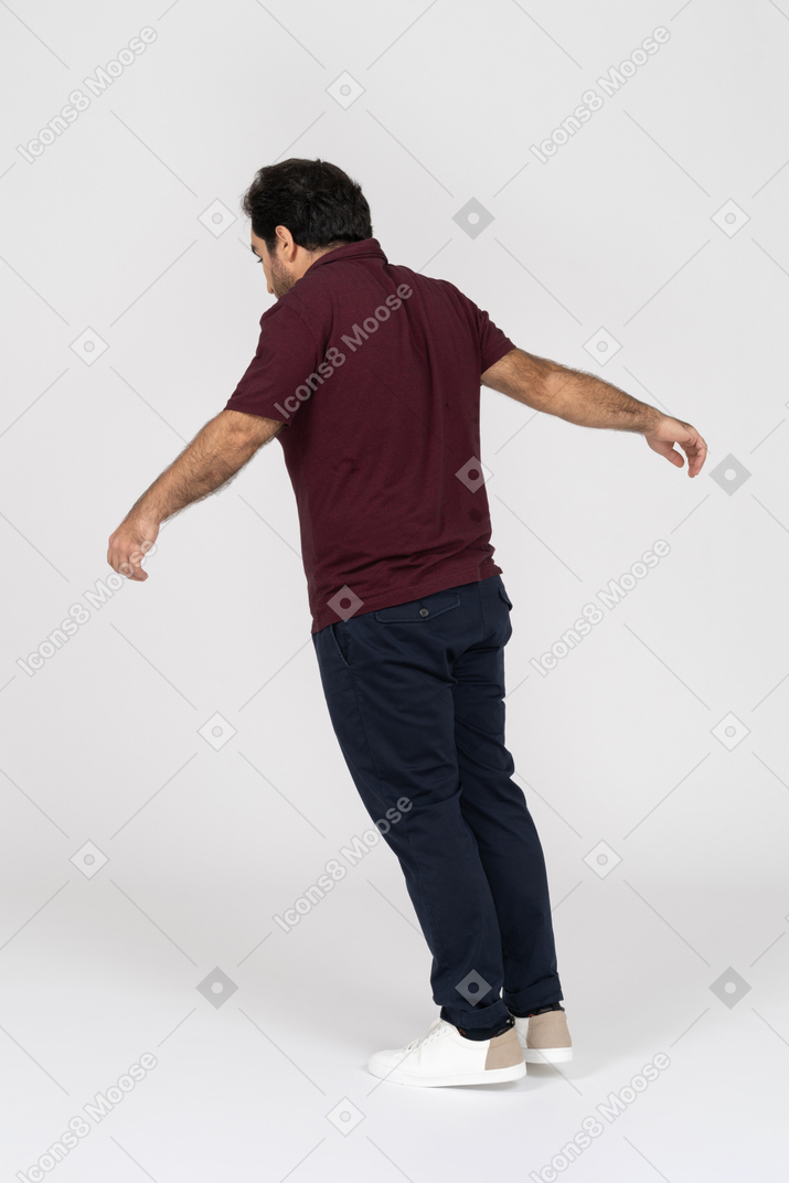 Back view of a man leaning forward