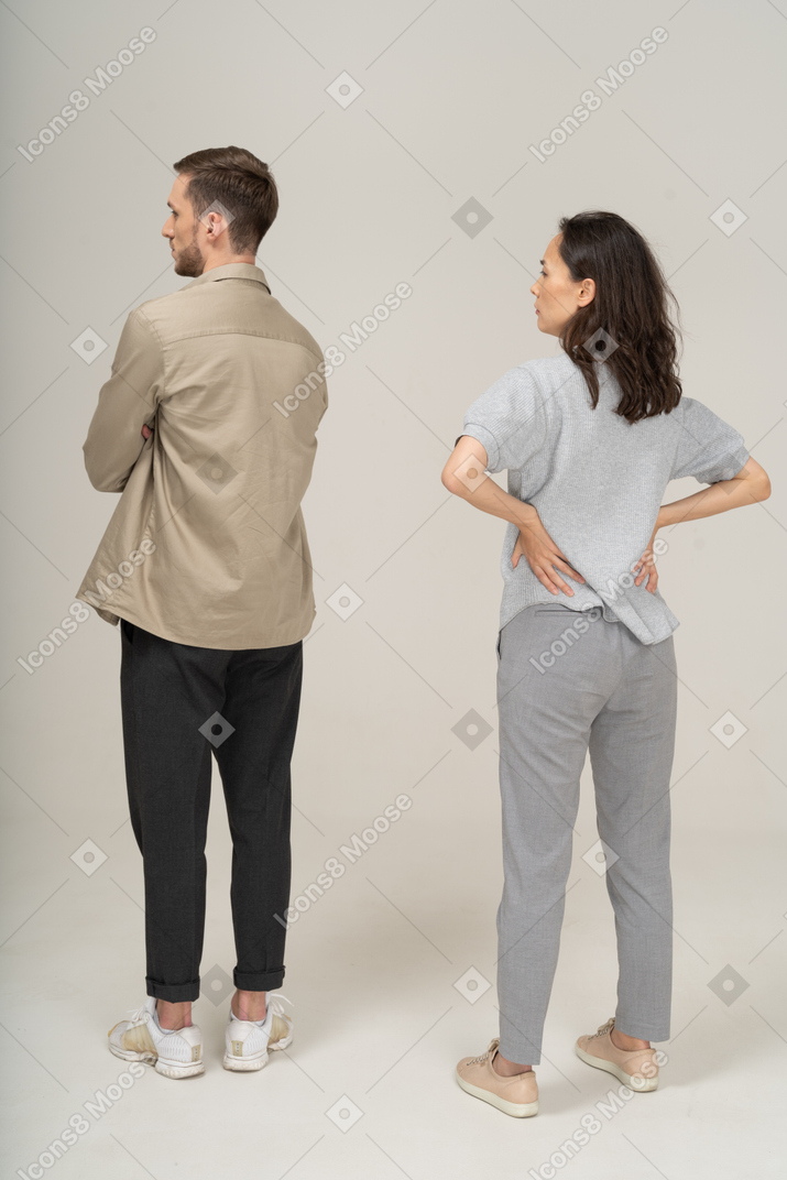 Three-quarter back view  of young couple being annoyed