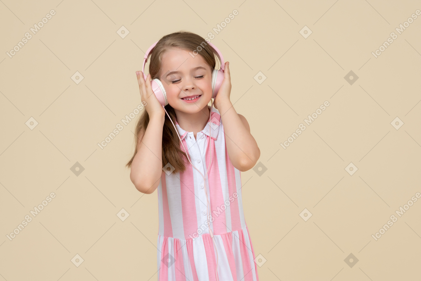 Cute little girl in the headphones listening to a music