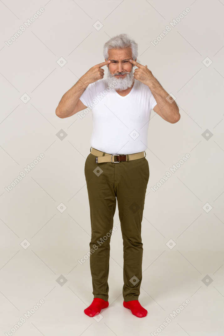 Man in casual clothes stretching his eyelids