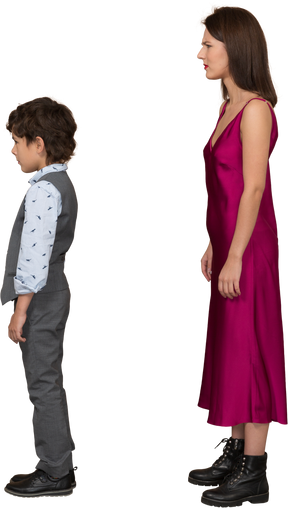 Disappointed woman in red dress with boy standing in profile