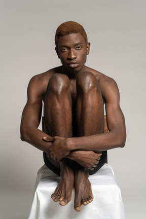 A man sitting on top of a white table