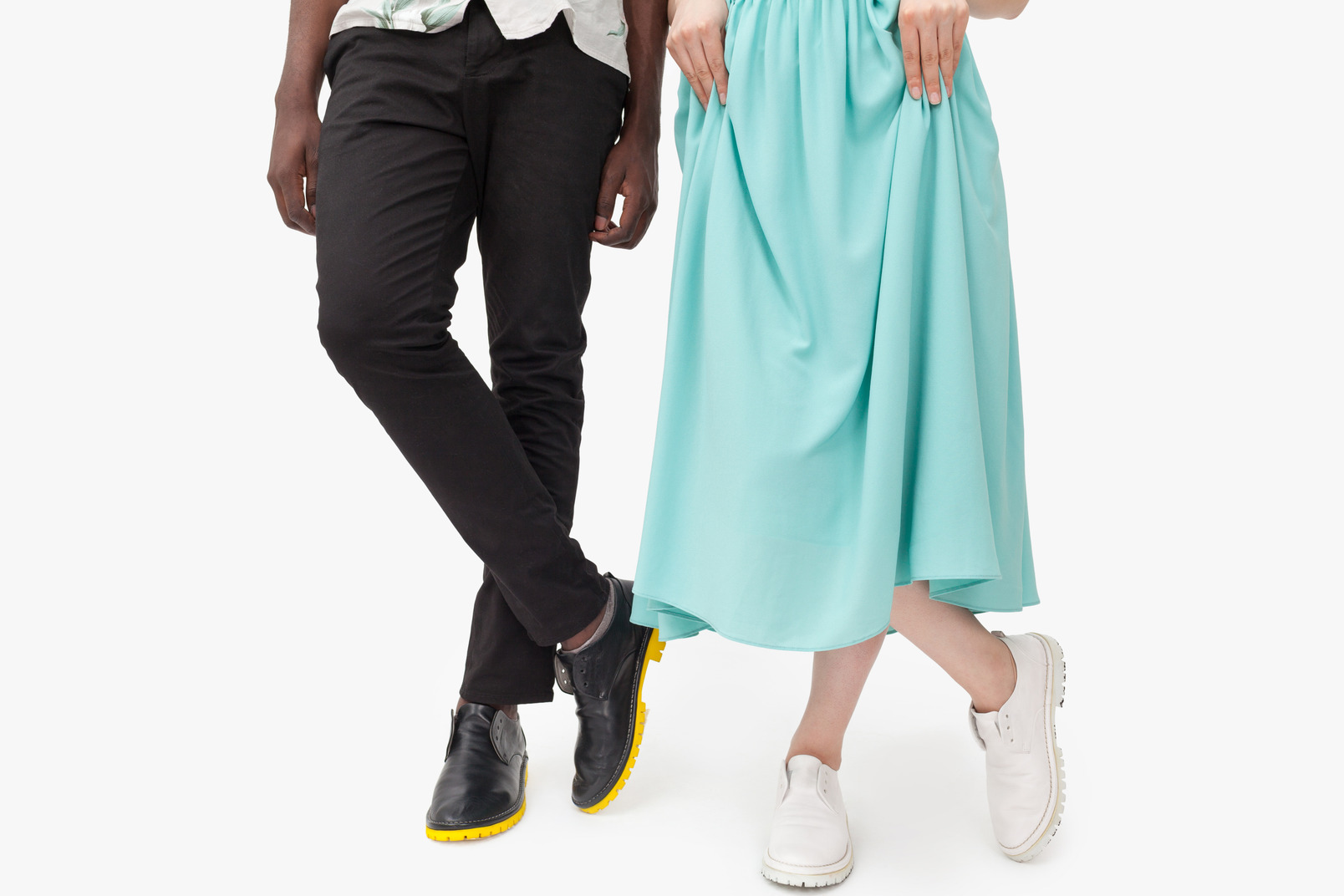 Interracial couple crossing legs and standing side by side