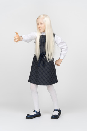 Schoolgirl smiling while showing thumbs up