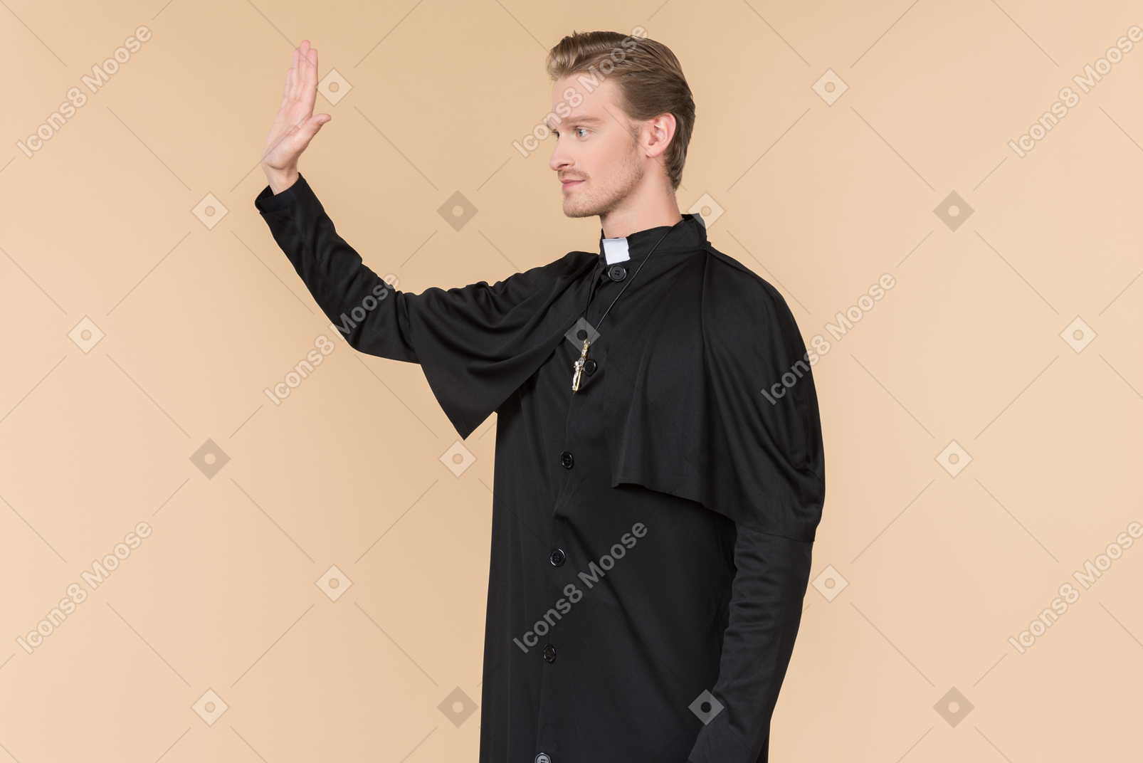 Catholic priest standing half sideways with his hand up