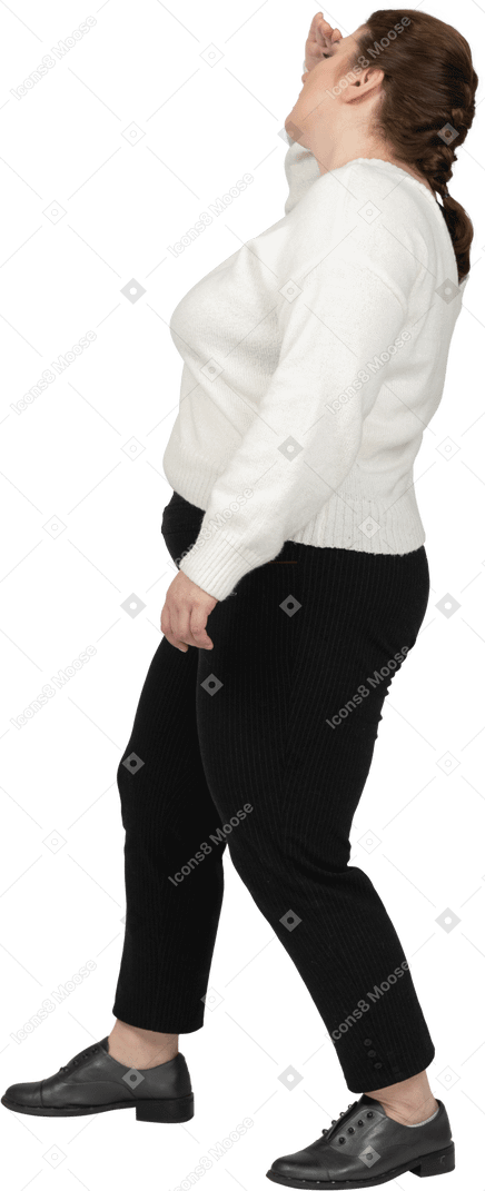Side view of a plump woman in casual clothes looking for someone