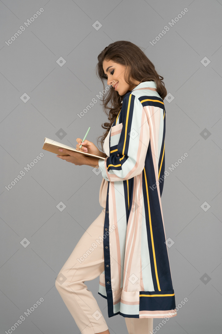 Beautiful woman holding a notebook
