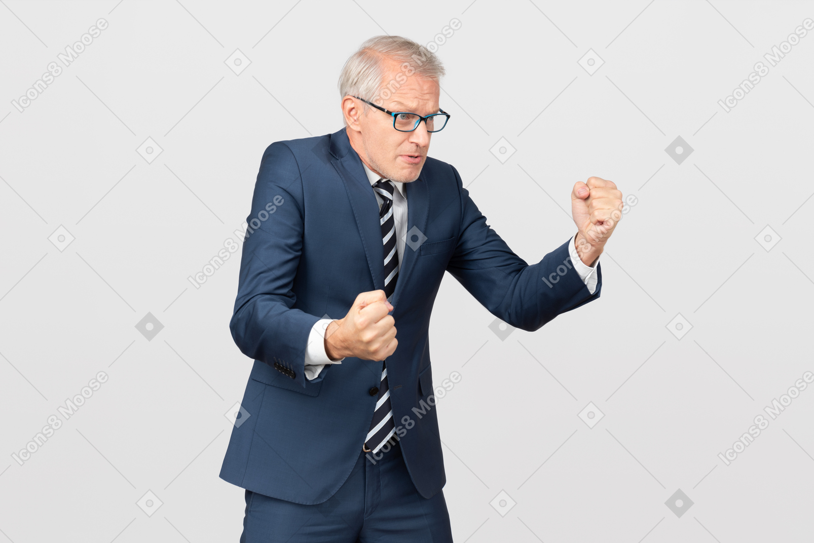Angry mature businessman holding clenched fists up
