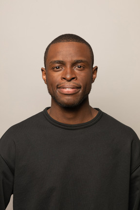 Calm young man looking at camera