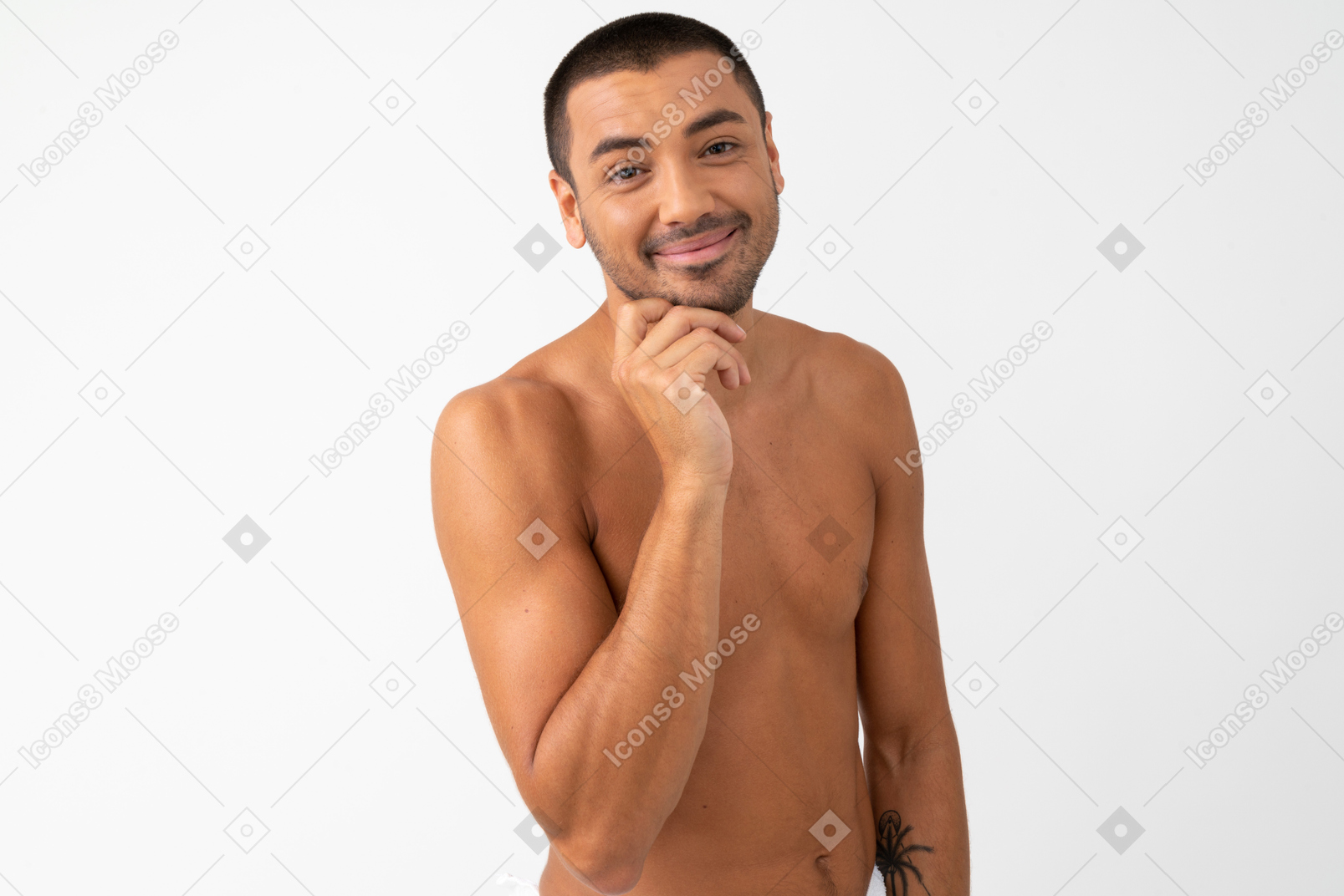 Barechested young man with light smile touching his chin