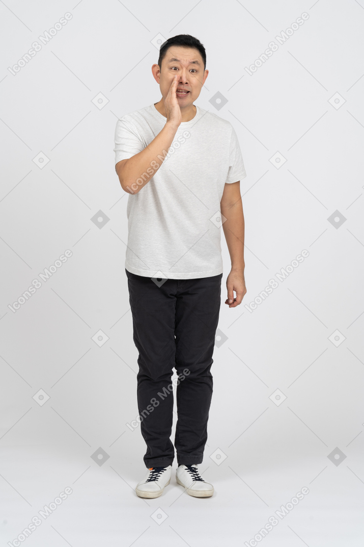 Front view of a man in casual clothes calling someone