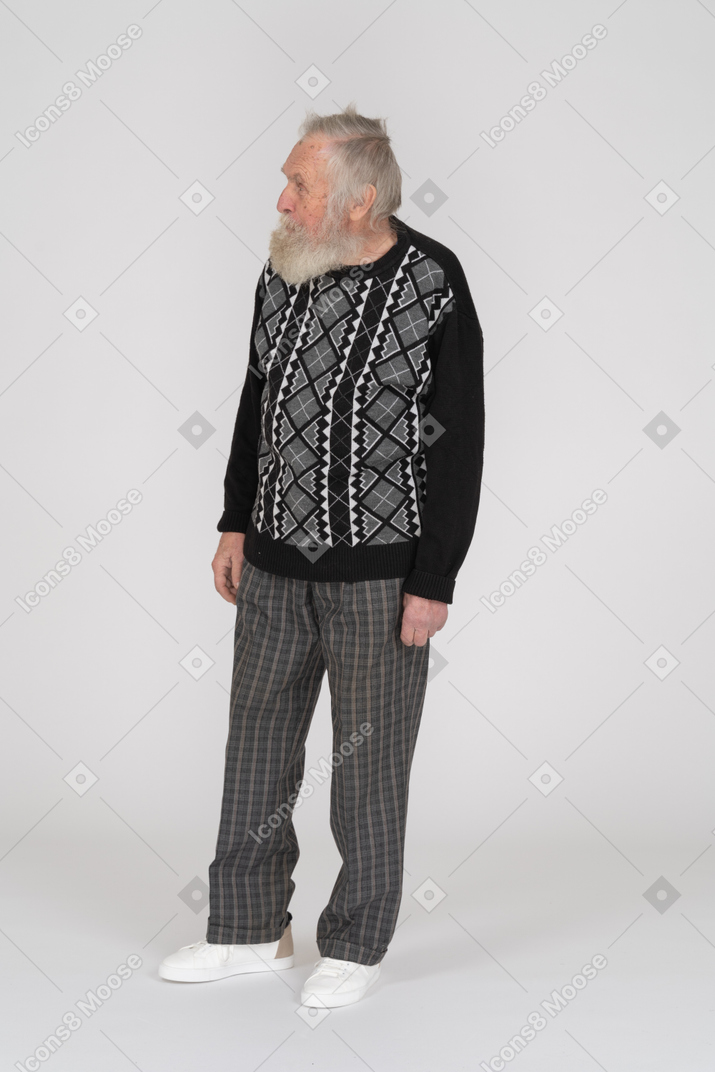 Front view of an old man standing with head turned sideways