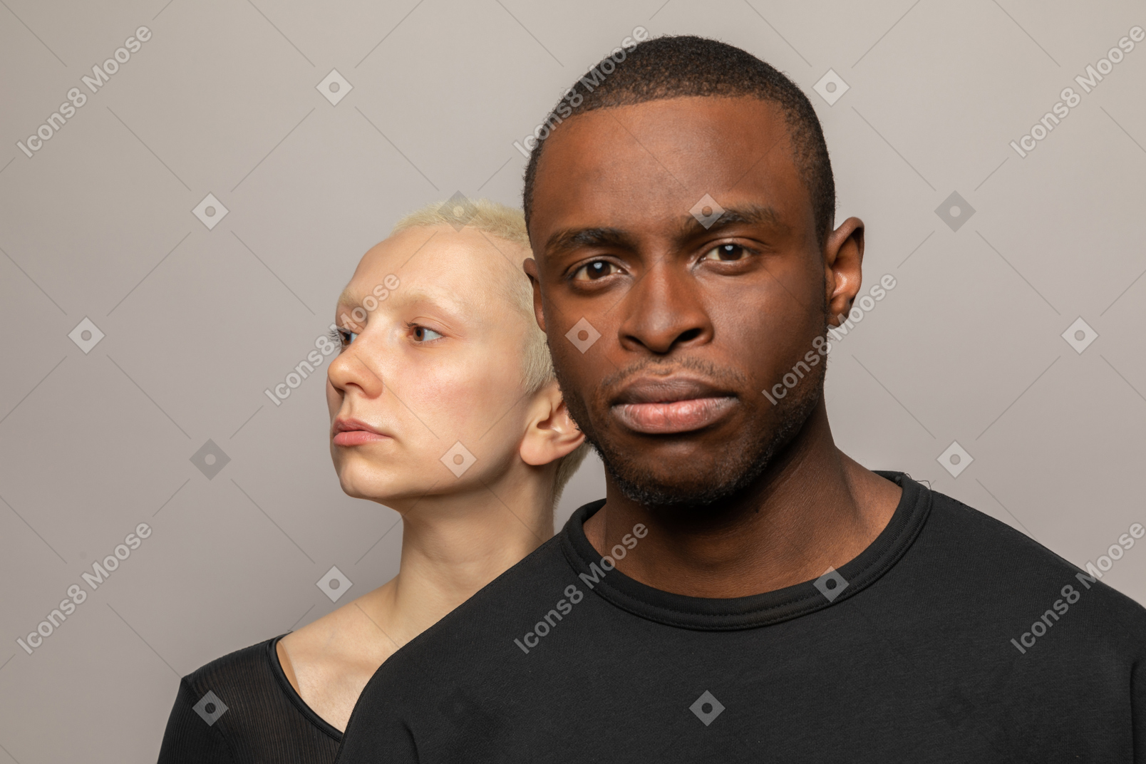 Woman standing behind a man looking aside