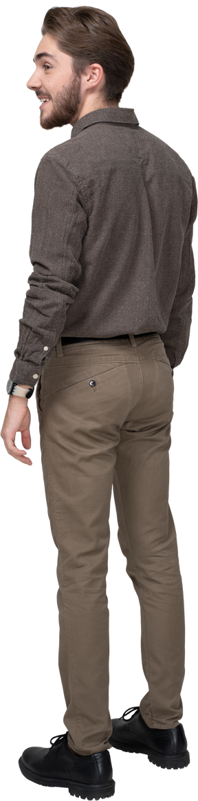 Three-quarter back view of a delighted young man in office clothing