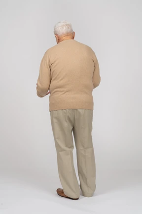 Rear view of an old man in casual clothes