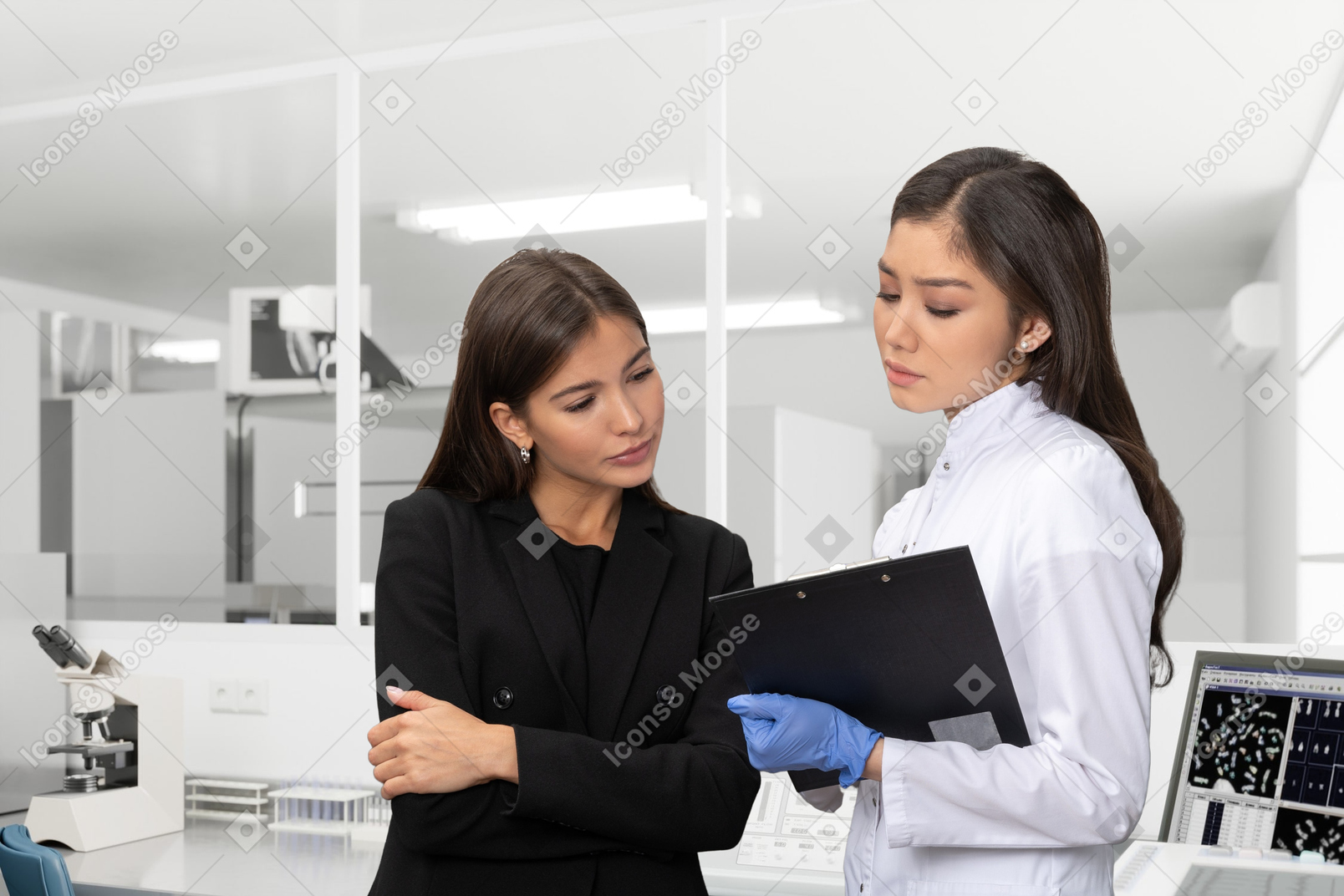 Two women talking to each other in a laboratory