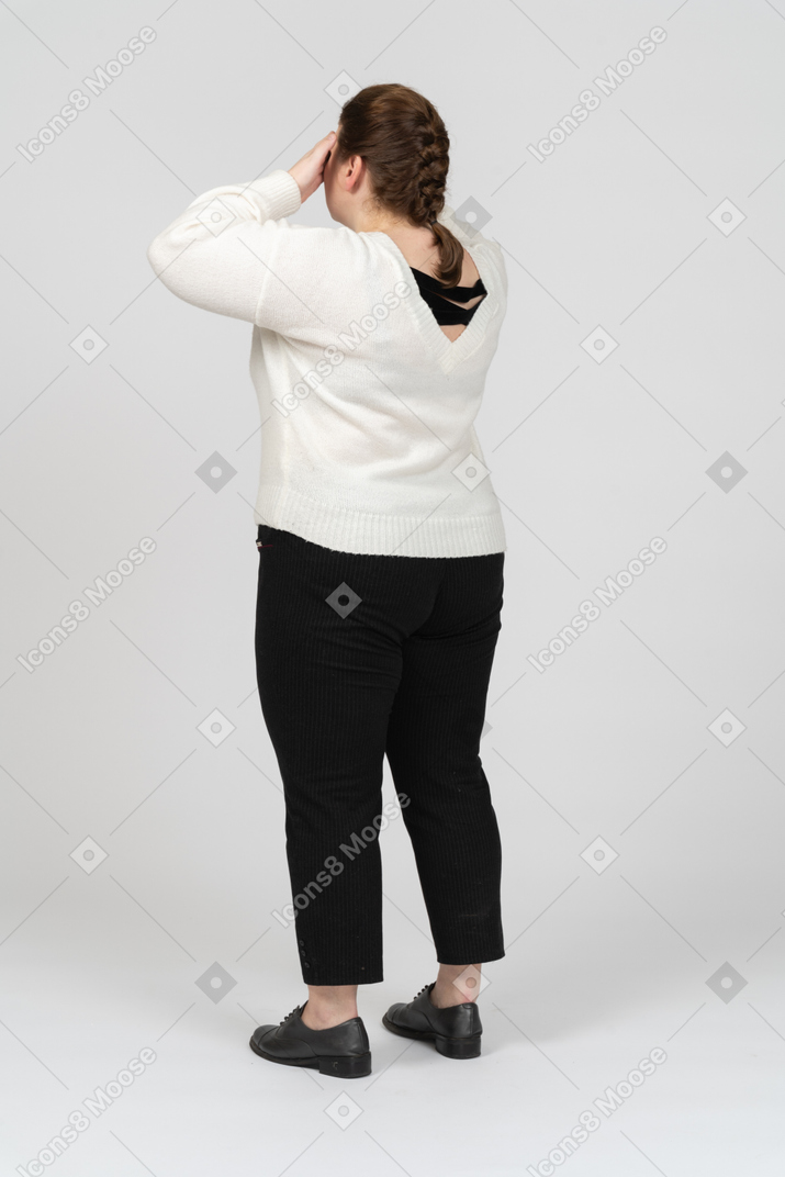 Plus size woman in casual clothes closing eyes with hands
